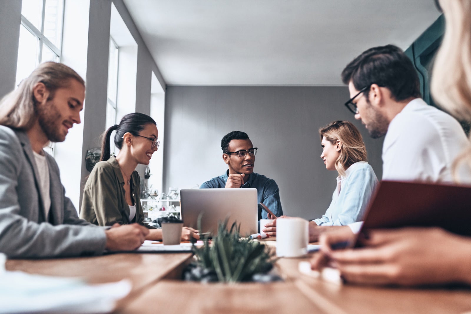 Employees gathered around a table in the office