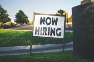 now hiring sign in yard