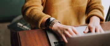 person writing a job description on a laptop