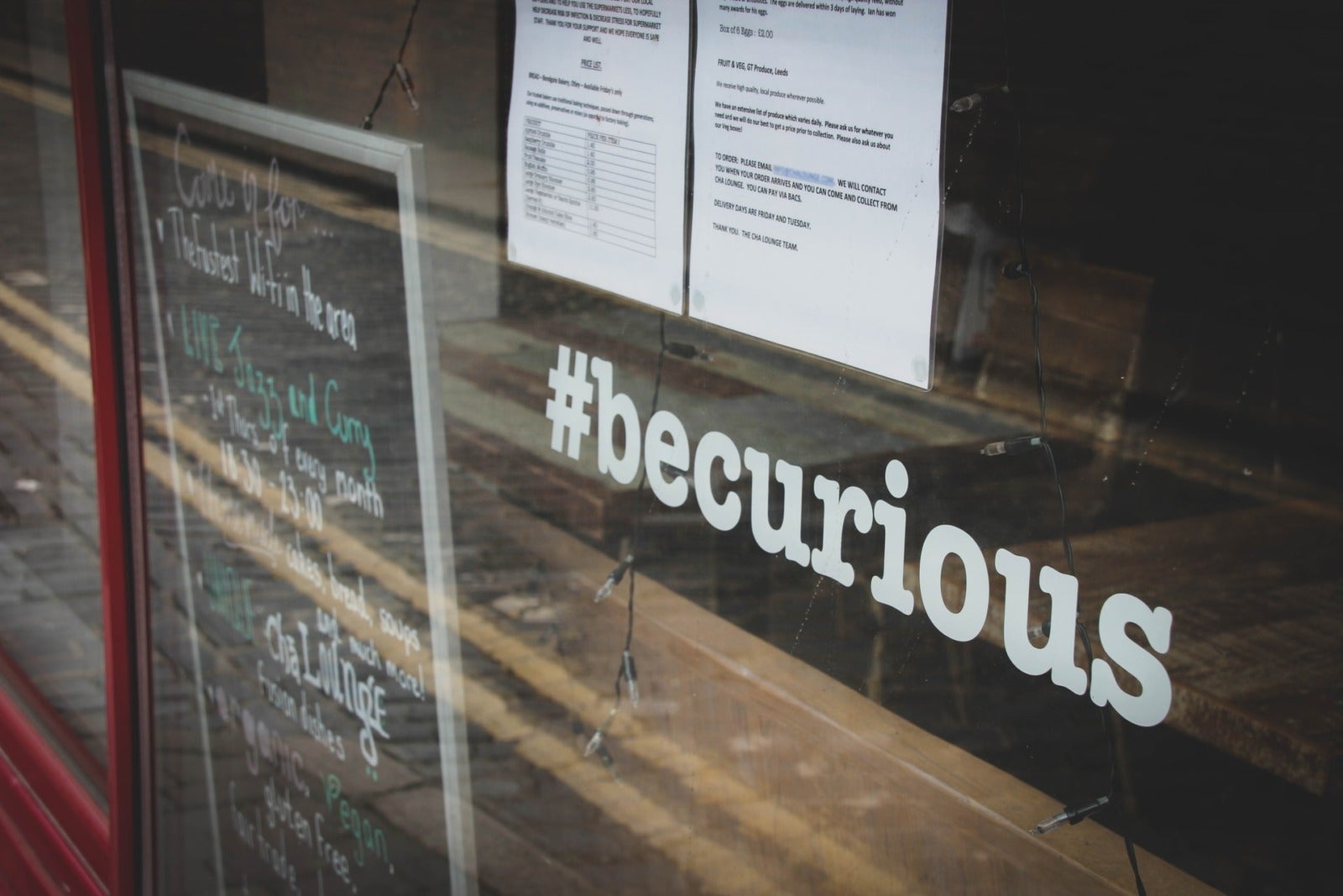 The Top 7 Questions to Ask a Franchisor About Recruitment - image of franchise shop window with #becurious on it