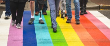 strategic sourcing best practices for diversity and inclusion - image of people walking over a rainbow carpet
