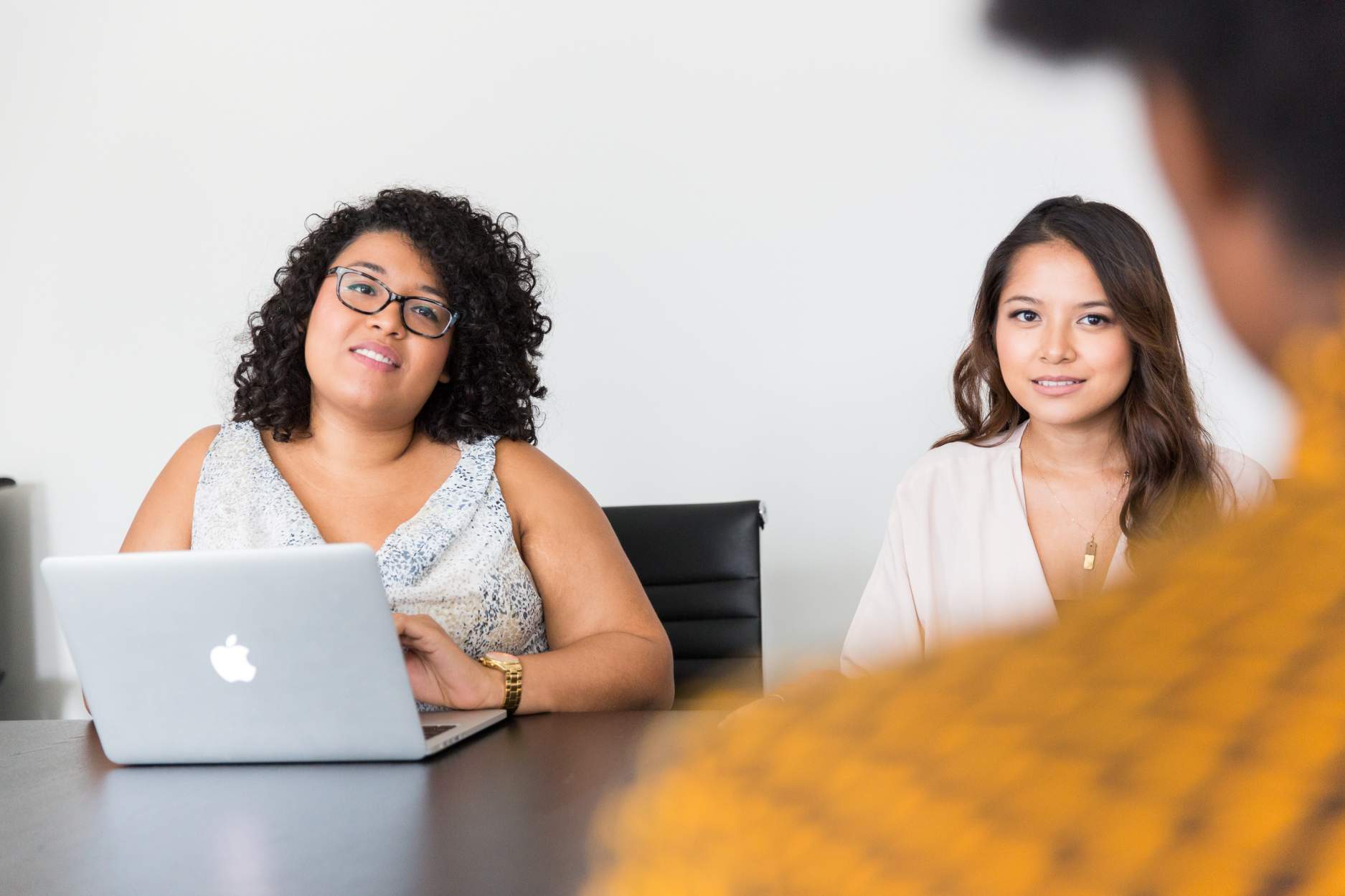 Marijuana and Employment: Everything You Need to Know - two women in an office setting with a laptop