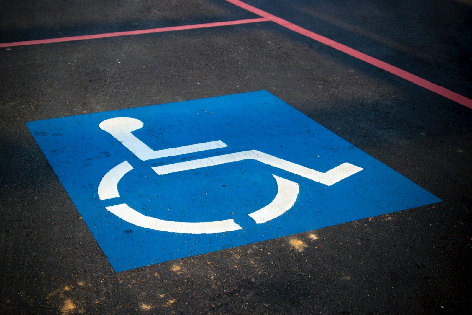 A disabled parking space in a parking lot.