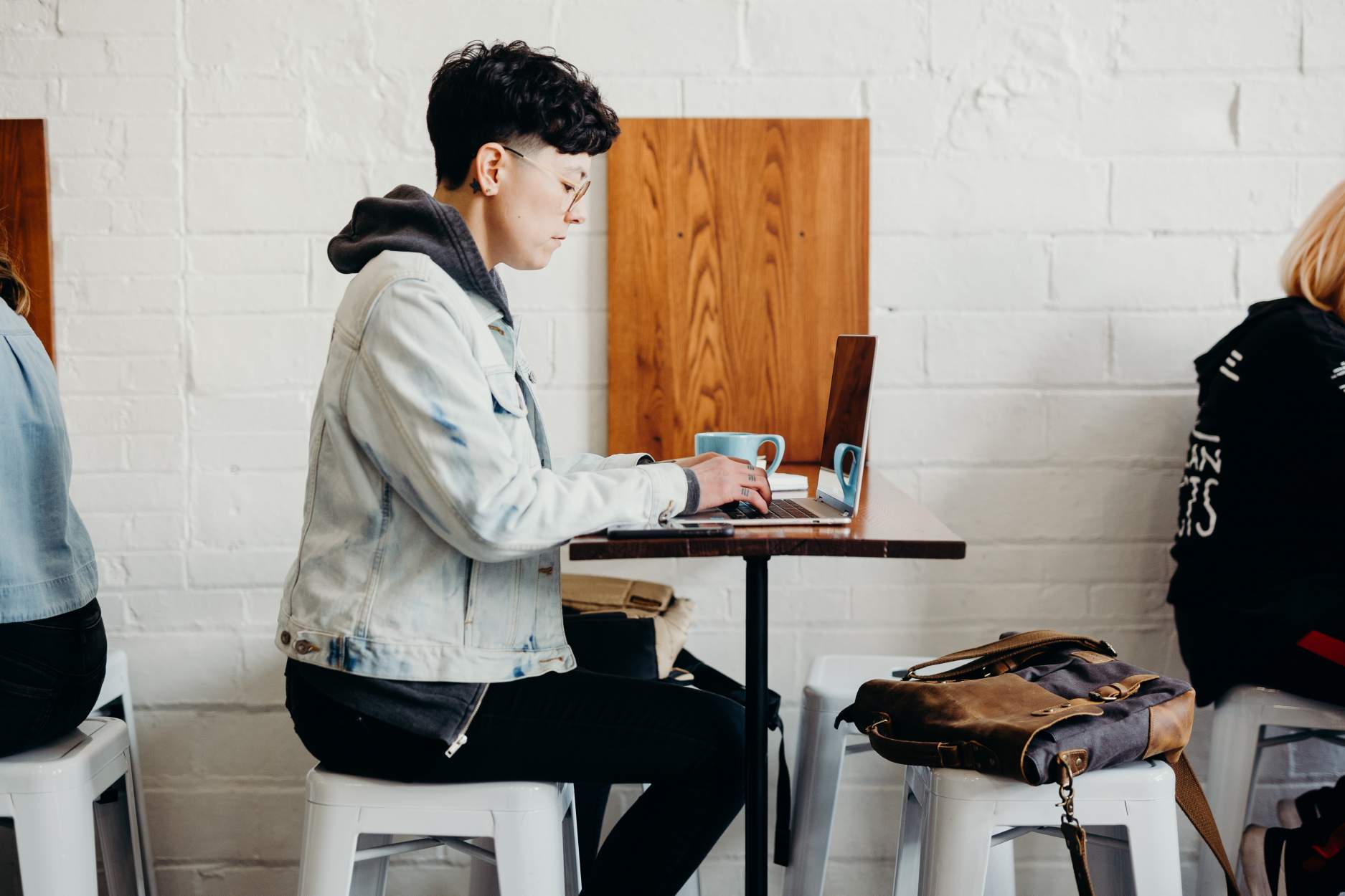 Person sitting at a table on their laptop