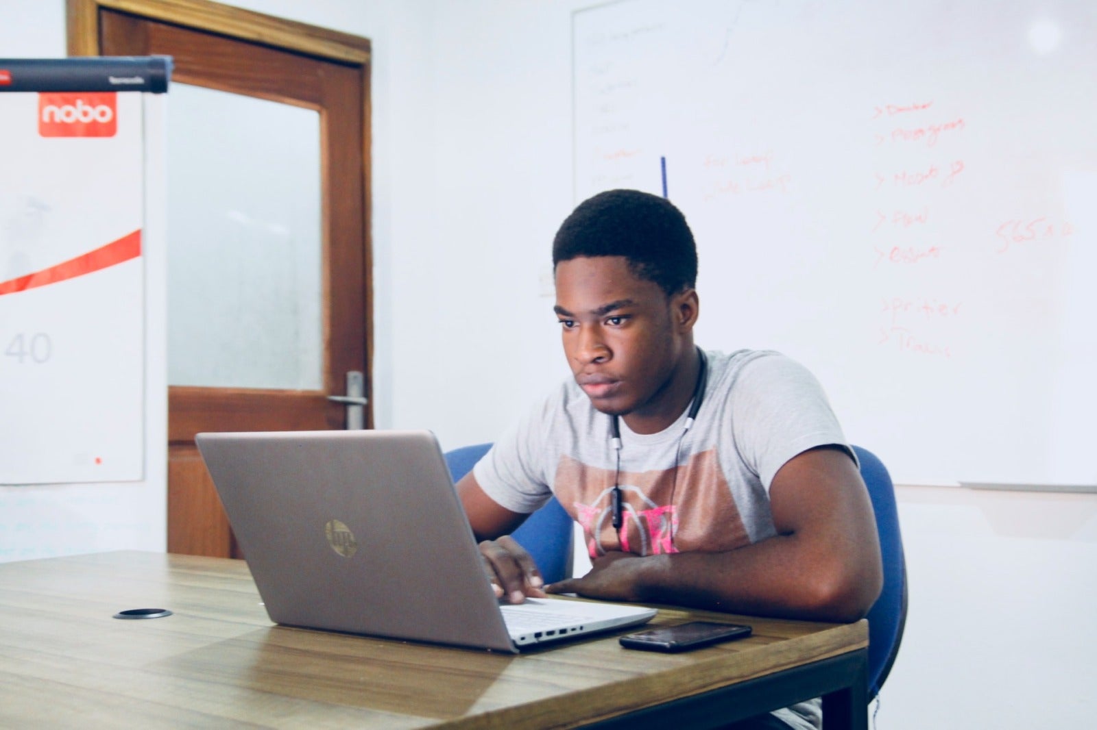 man scrolling on a laptop