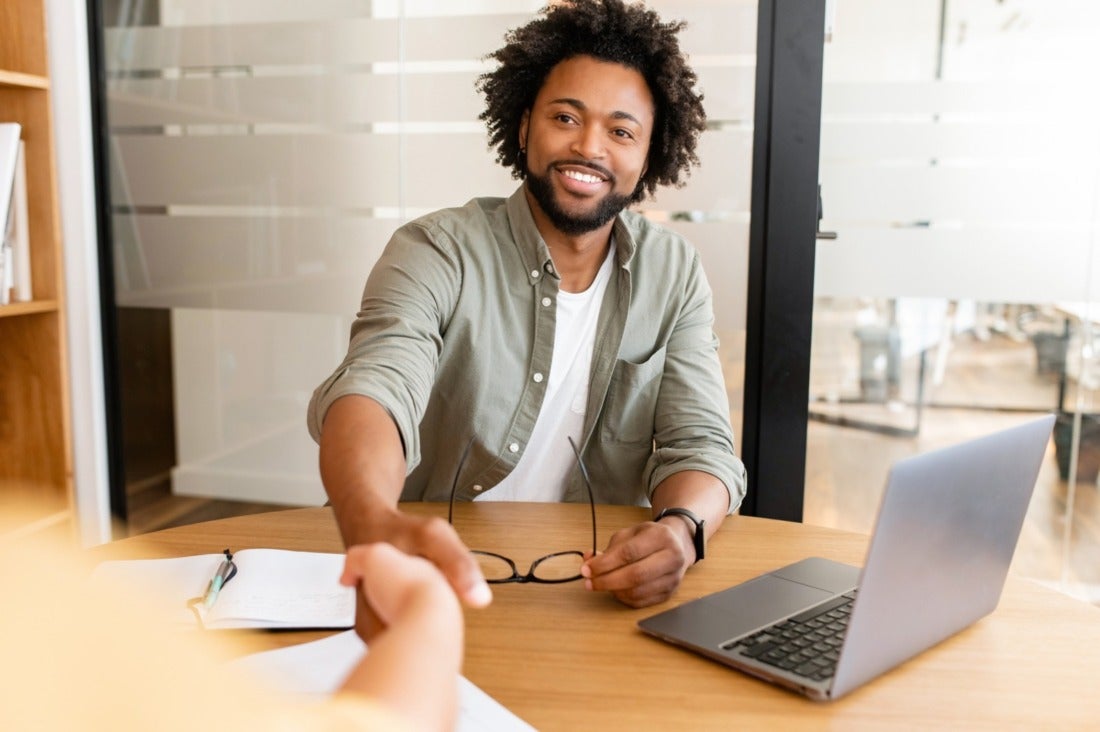 Happy Male African American Hiring Manager Shaking Hands with Candidate