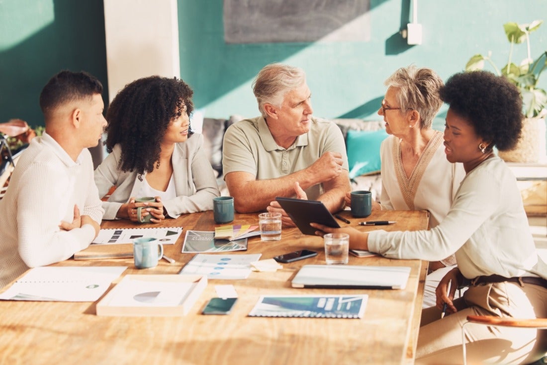 Diverse Group of Employees Meeting at an Office Desk