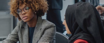 Two colleagues pensively looking at a report in an office