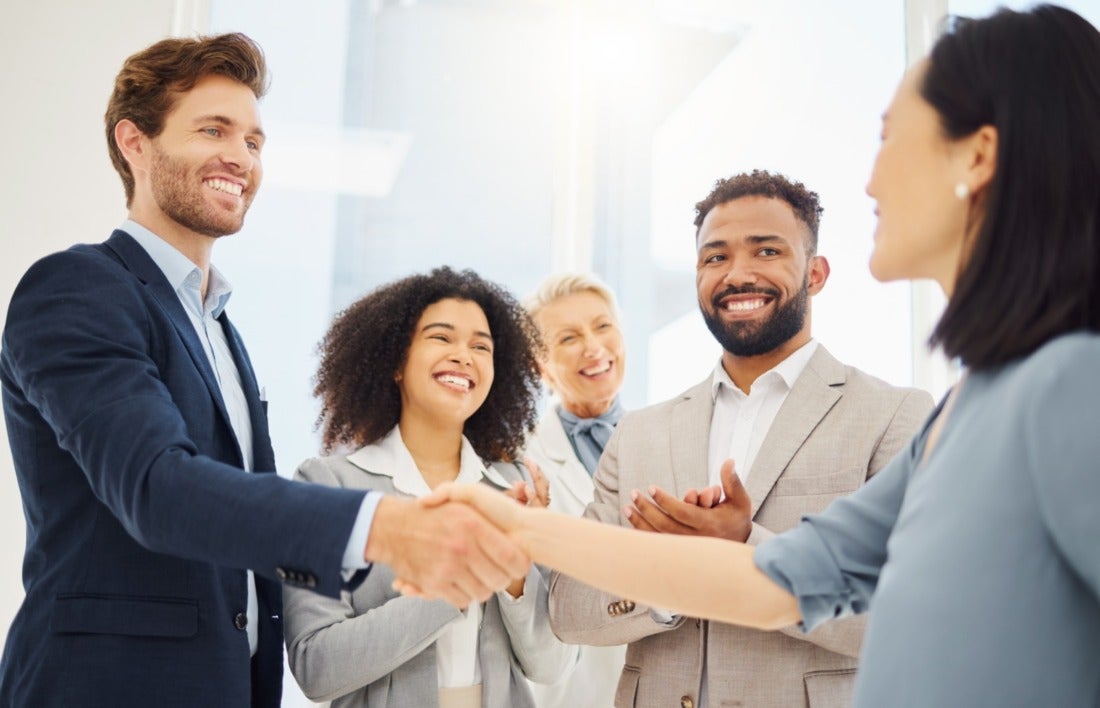 Group of professionals clapping and shaking hands