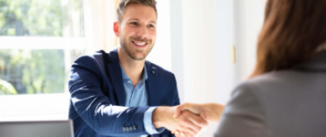 hiring manager and job candidate shake hands
