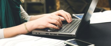 woman typing laptop computer