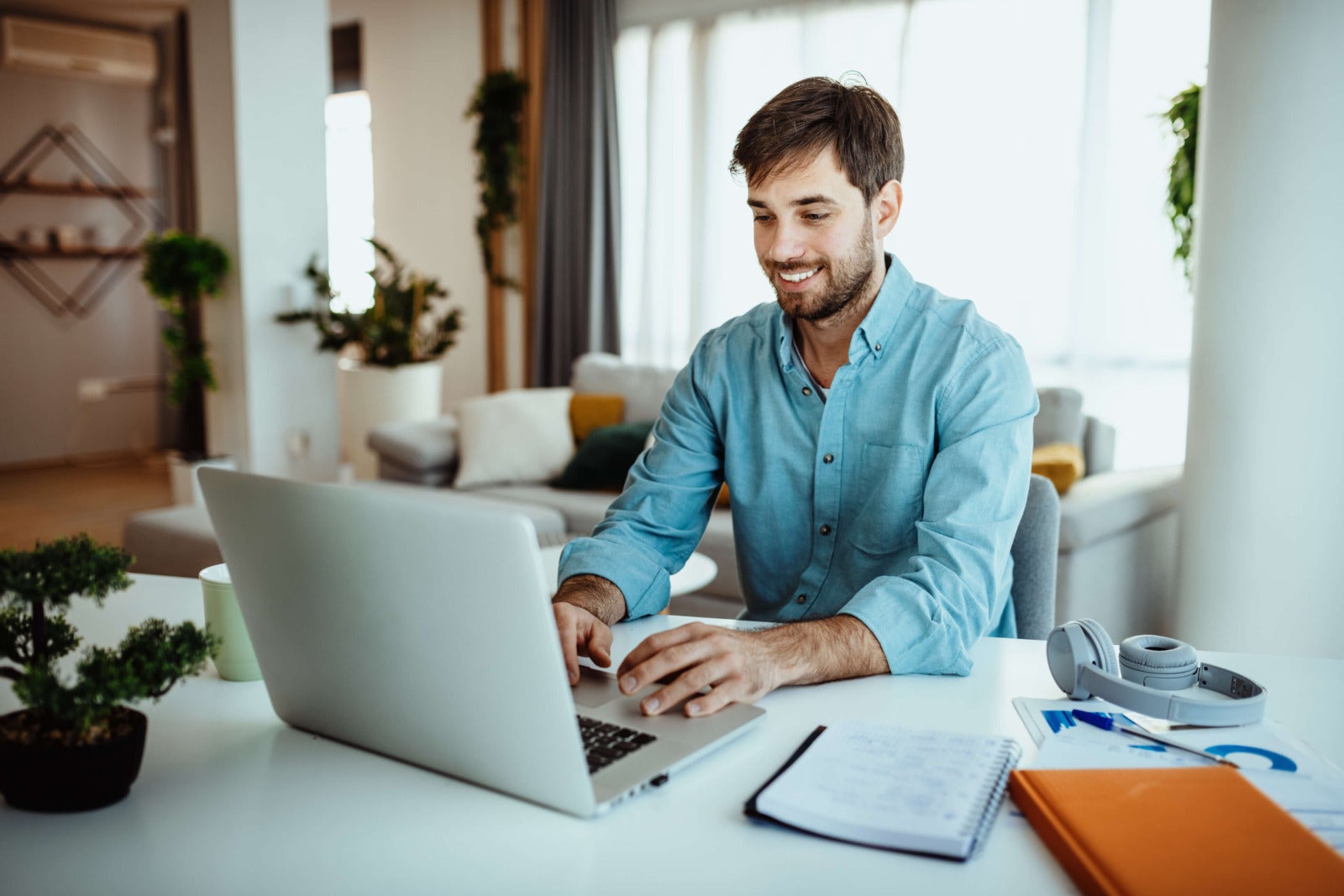 worker types on laptop at home office