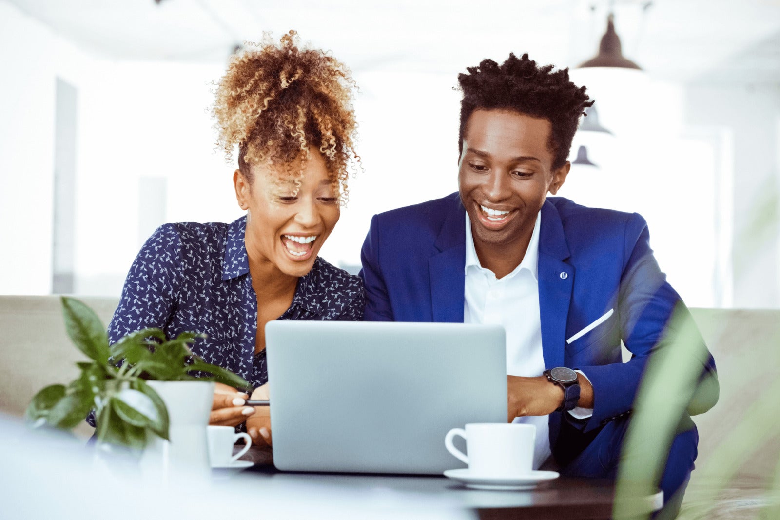 business leaders analyze data and docs on laptop together