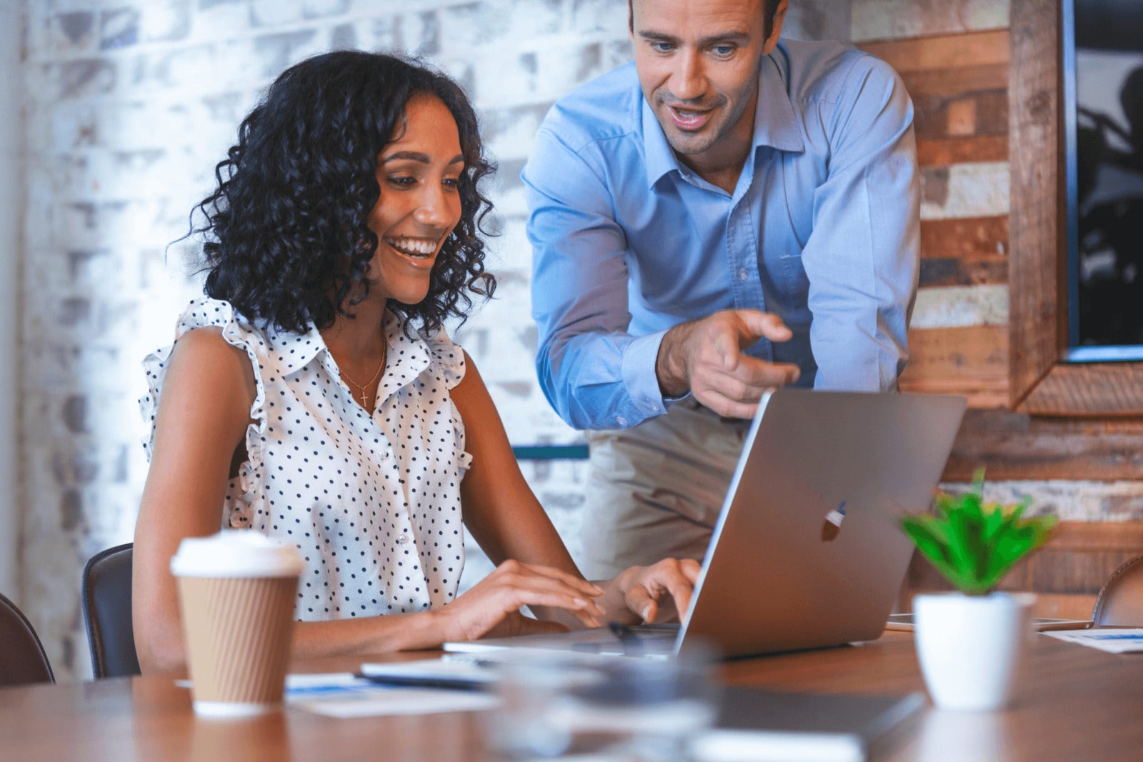 small business leaders look at computer together at desk