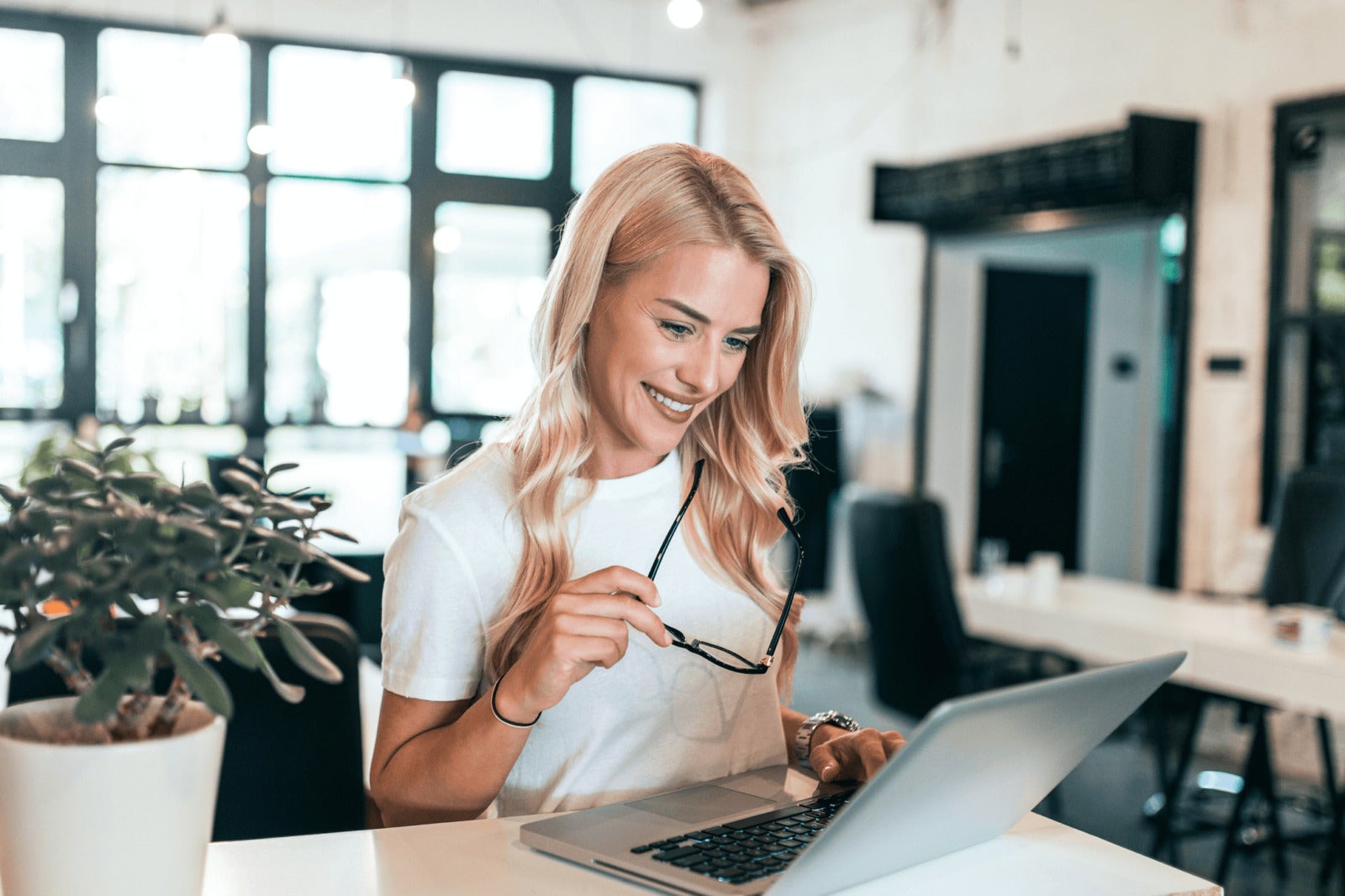 smiling small business owner working on laptop