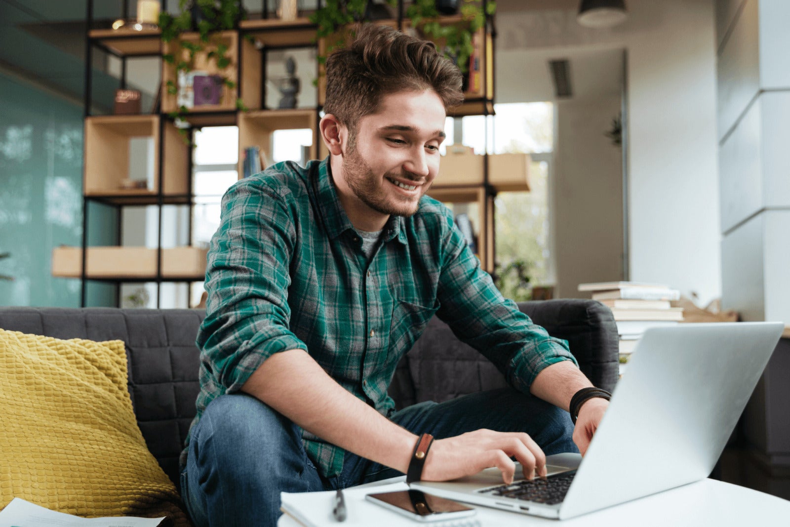 young business professional working on laptop at home
