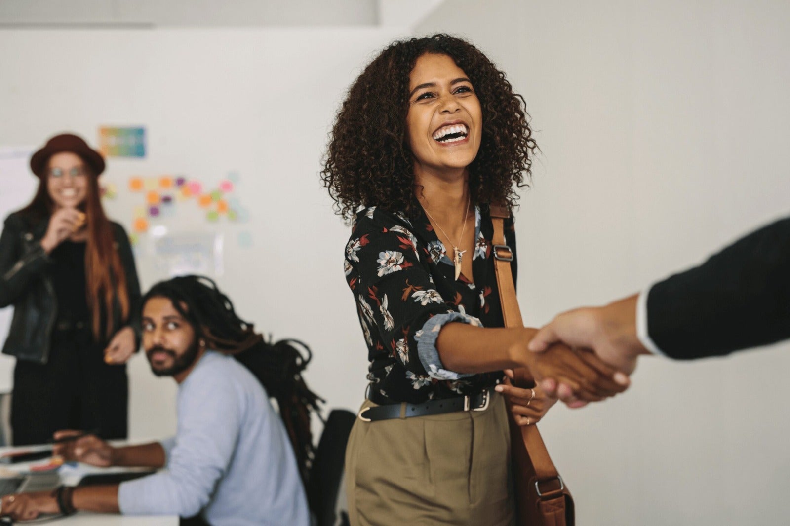 job candidate shakes interviewers hand during in person interview